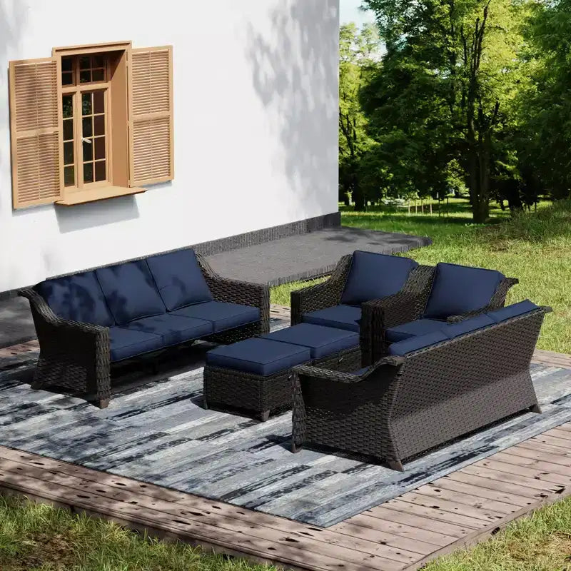 Ensemble de mobilier de jardin UPTIOT avec deux canapés, des chaises, des poufs et une table brasero pour des rassemblements spacieux